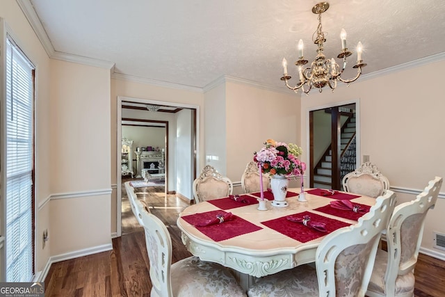 2582 Fairview Ln, Jonesboro, GA 30236 - dining room featuring ornamental molding, baseboards, an inviting chandelier, and wood finished floors