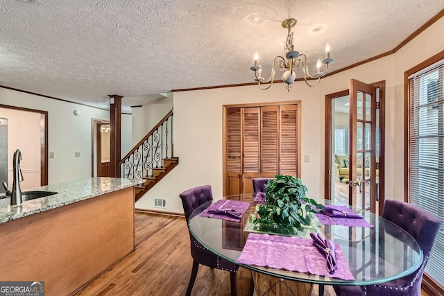 2582 Fairview Ln, Jonesboro, GA 30236 - dining space with an inviting chandelier, visible vents, light wood-type flooring, and ornamental molding