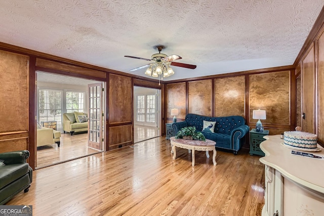 2582 Fairview Ln, Jonesboro, GA 30236 - living area featuring a decorative wall, ornamental molding, light wood-style floors, and ceiling fan