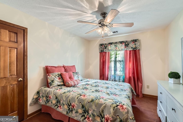 2582 Fairview Ln, Jonesboro, GA 30236 - bedroom with visible vents, ceiling fan, baseboards, a textured ceiling, and dark wood-style flooring