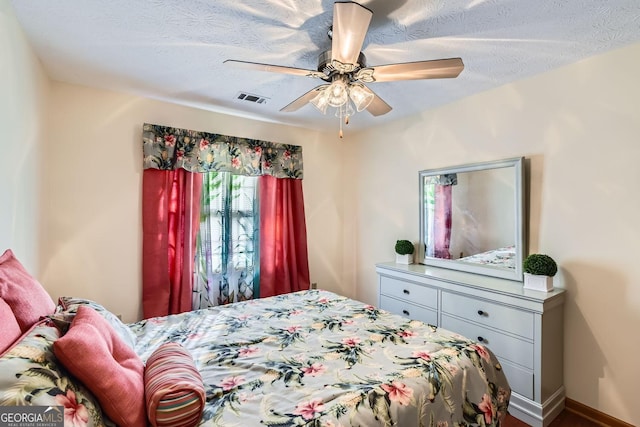 2582 Fairview Ln, Jonesboro, GA 30236 - bedroom with baseboards, a ceiling fan, visible vents, and a textured ceiling