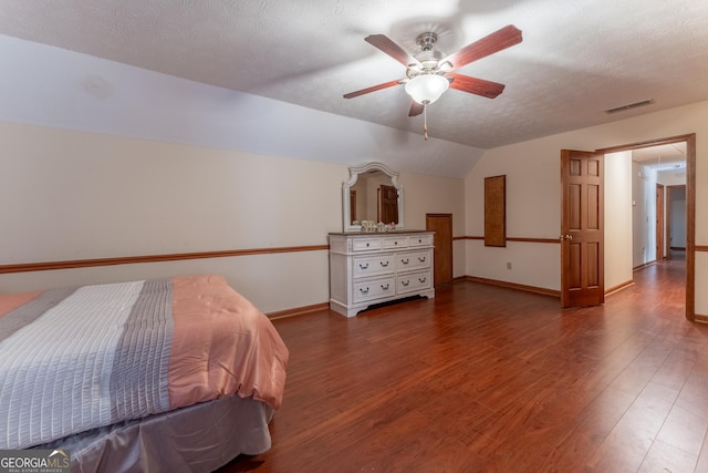 2582 Fairview Ln, Jonesboro, GA 30236 - bedroom with visible vents, baseboards, vaulted ceiling, wood finished floors, and a textured ceiling