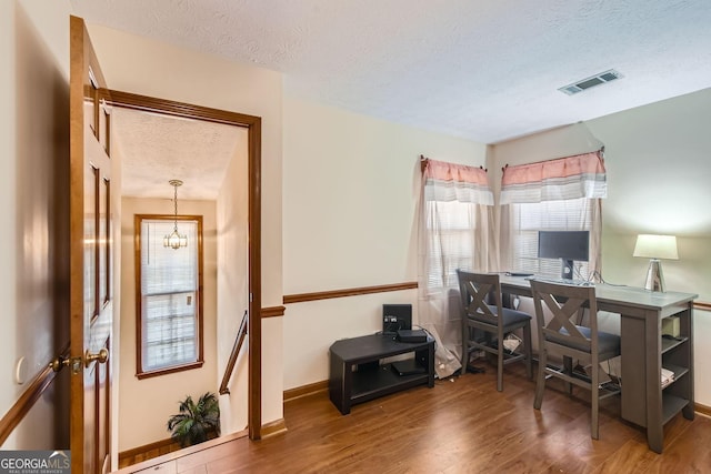 2582 Fairview Ln, Jonesboro, GA 30236 - office with wood finished floors, baseboards, visible vents, a textured ceiling, and a chandelier