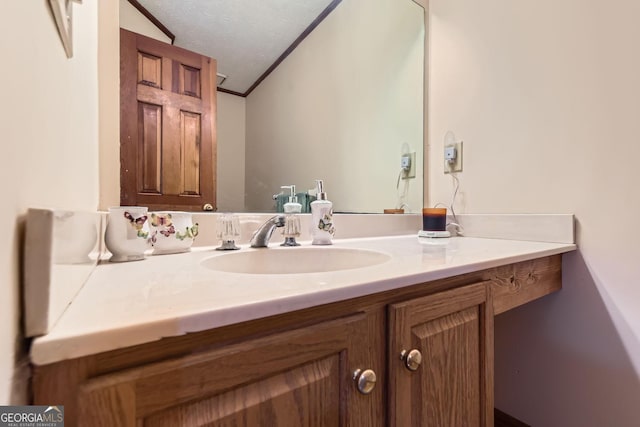 2582 Fairview Ln, Jonesboro, GA 30236 - bathroom featuring vanity, ornamental molding, and a textured ceiling