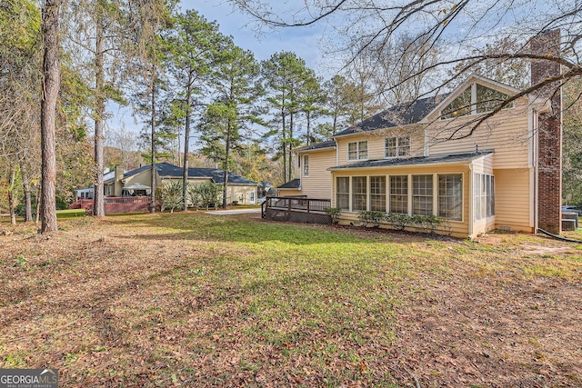 2582 Fairview Ln, Jonesboro, GA 30236 - rear view of house featuring a lawn, a sunroom, and a chimney