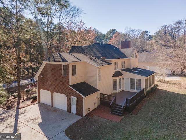 2582 Fairview Ln, Jonesboro, GA 30236 - rear view of property featuring brick siding, an attached garage, concrete driveway, and a chimney