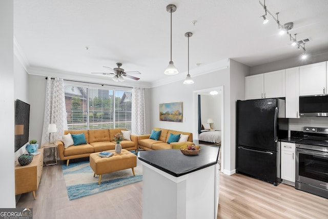 kitchen with white cabinetry, pendant lighting, stainless steel appliances, and light hardwood / wood-style floors