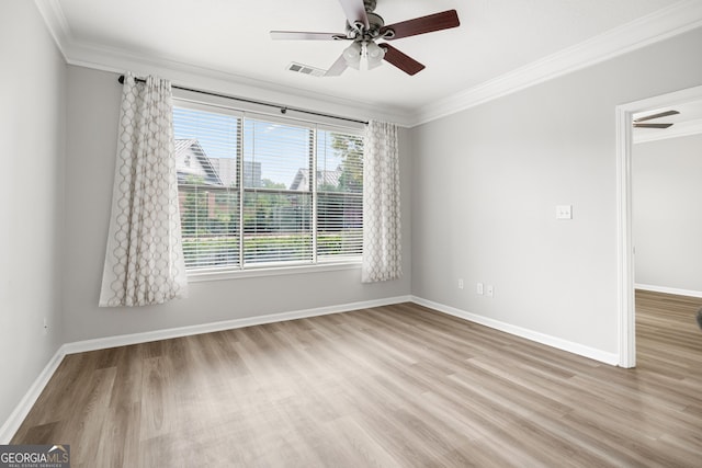 empty room featuring ceiling fan, light hardwood / wood-style floors, and crown molding