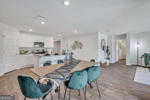 dining room featuring light hardwood / wood-style floors