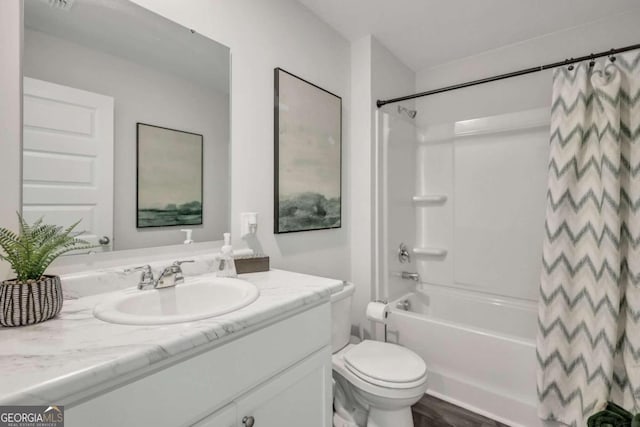 full bathroom with hardwood / wood-style flooring, vanity, toilet, and shower / bath combo with shower curtain