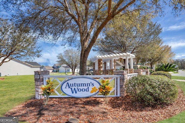 community sign featuring a lawn