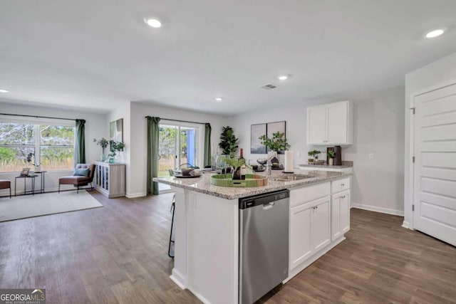 kitchen with sink, white cabinets, a kitchen island with sink, stainless steel dishwasher, and light stone countertops