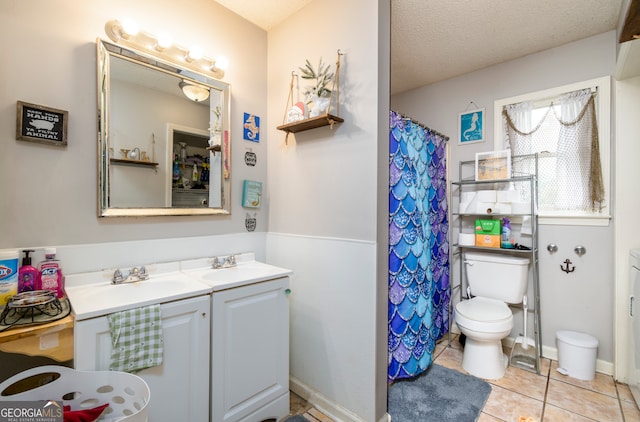 bathroom with toilet, tile patterned floors, a textured ceiling, vanity, and a shower with shower curtain