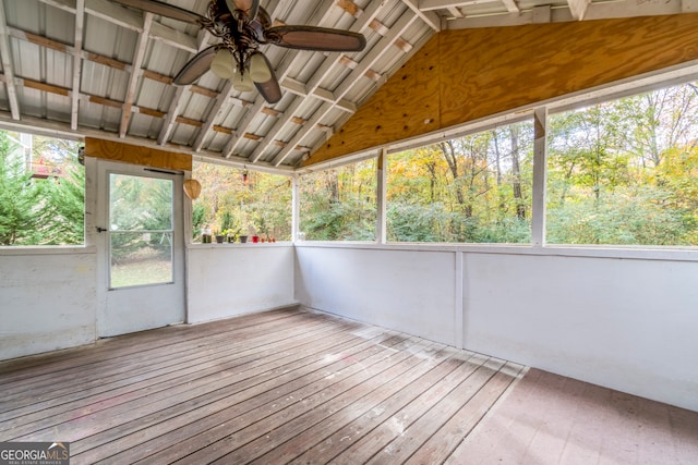 unfurnished sunroom with ceiling fan and vaulted ceiling