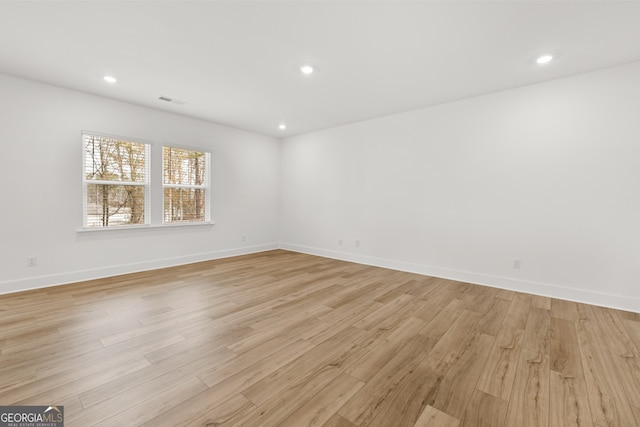 unfurnished room with light hardwood / wood-style floors