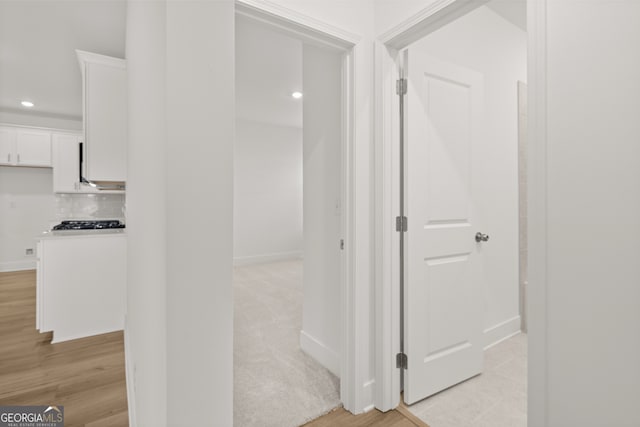 corridor with light wood-type flooring