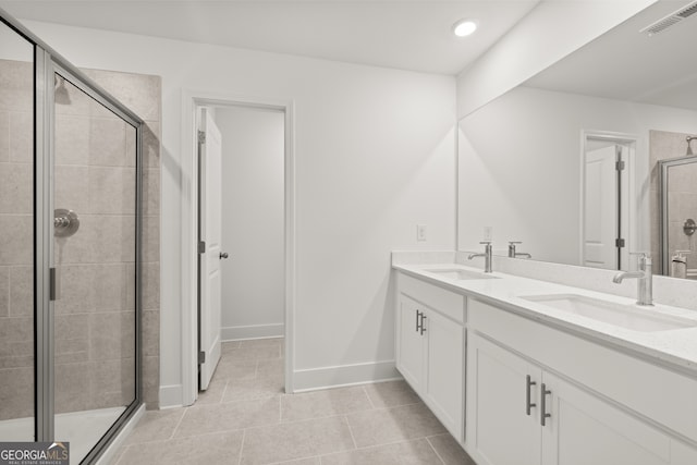 bathroom with tile patterned floors, vanity, and a shower with shower door