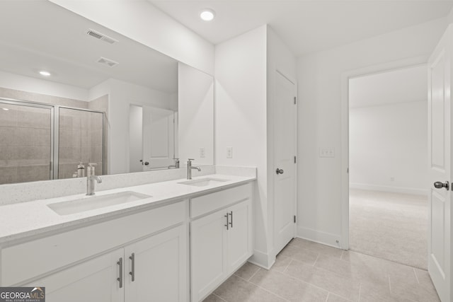 bathroom featuring vanity, tile patterned floors, and a shower with shower door