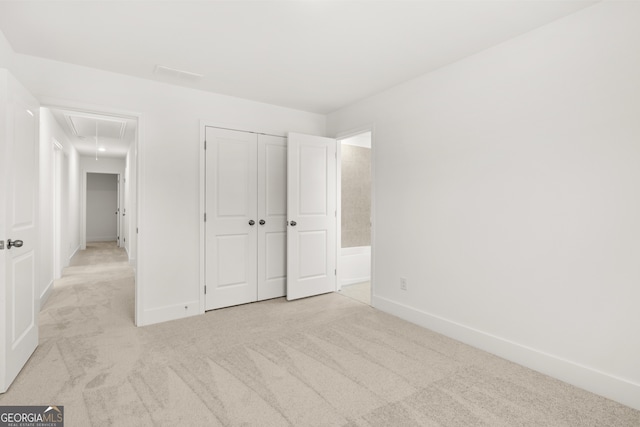 unfurnished bedroom featuring light carpet