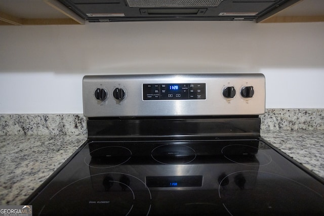 room details with stainless steel electric stove and light stone counters