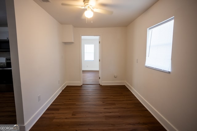 spare room featuring ceiling fan and dark hardwood / wood-style floors