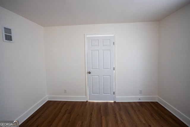 unfurnished room featuring dark wood-type flooring