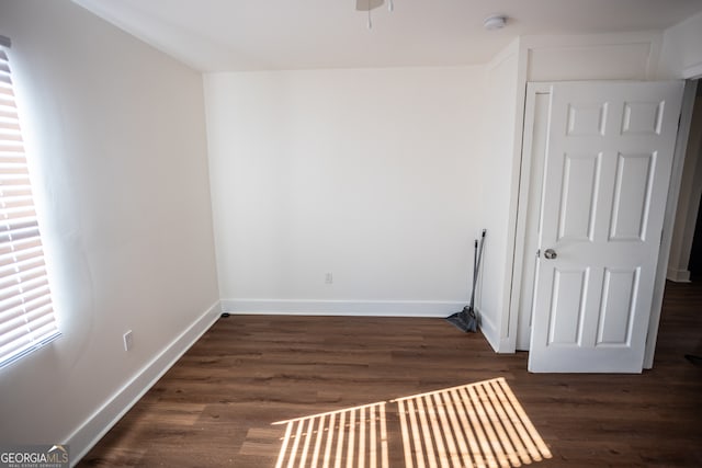 unfurnished room featuring dark hardwood / wood-style flooring