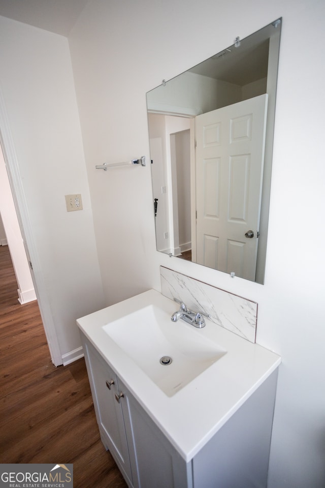 bathroom with hardwood / wood-style floors and vanity