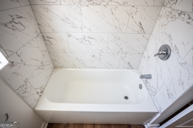 bathroom featuring a tub to relax in