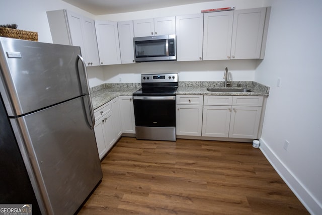 kitchen featuring white cabinets, dark hardwood / wood-style floors, sink, and stainless steel appliances