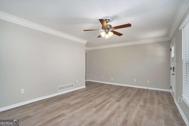 spare room featuring ornamental molding, light hardwood / wood-style floors, and ceiling fan