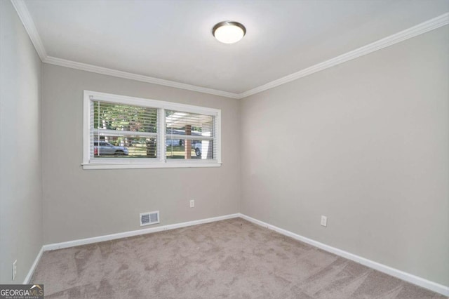 carpeted spare room featuring crown molding