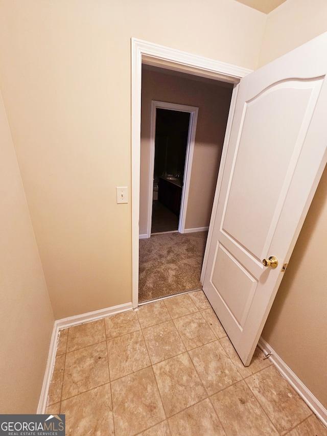 corridor featuring light tile patterned floors