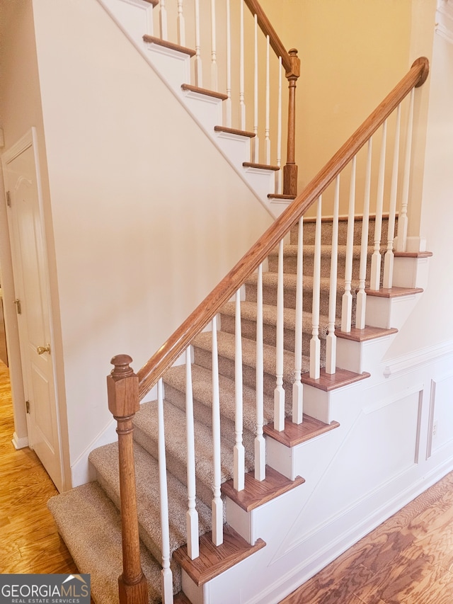 staircase with hardwood / wood-style flooring