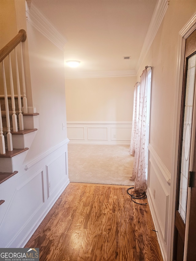 hall featuring hardwood / wood-style floors and crown molding