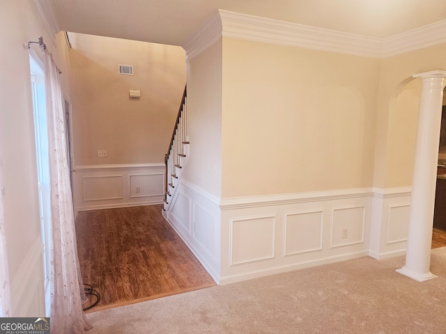 hallway featuring ornamental molding, carpet floors, and decorative columns