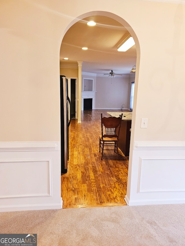 hall with ornamental molding and hardwood / wood-style flooring