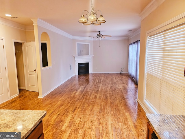 unfurnished living room with ornamental molding, wood-type flooring, and ceiling fan with notable chandelier