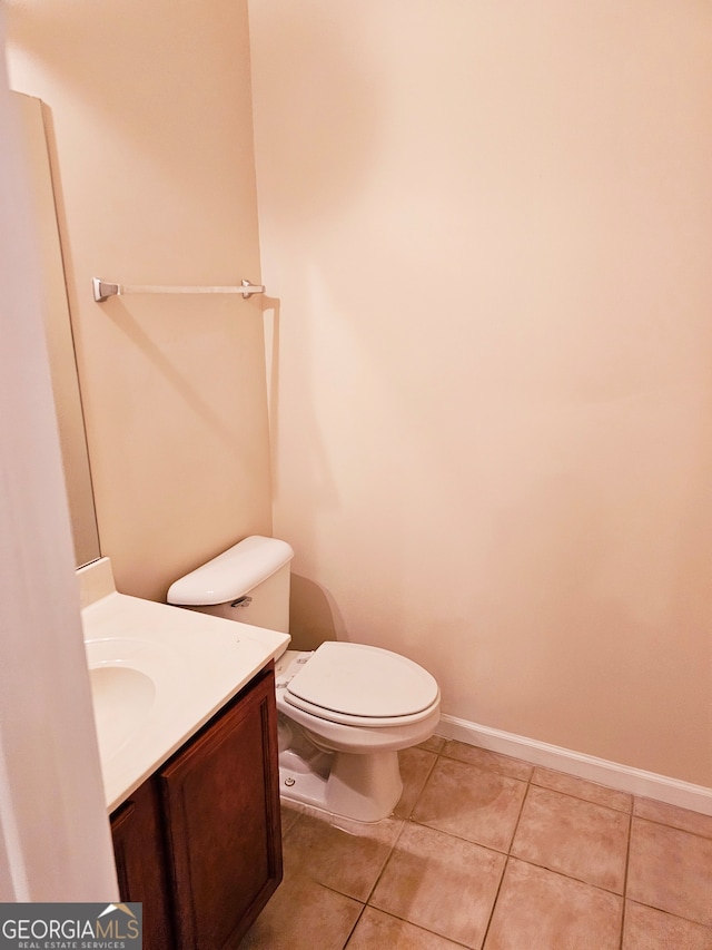 bathroom with vanity, toilet, and tile patterned floors