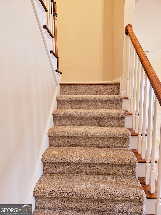 stairs featuring hardwood / wood-style flooring