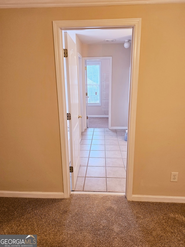 hall with light colored carpet