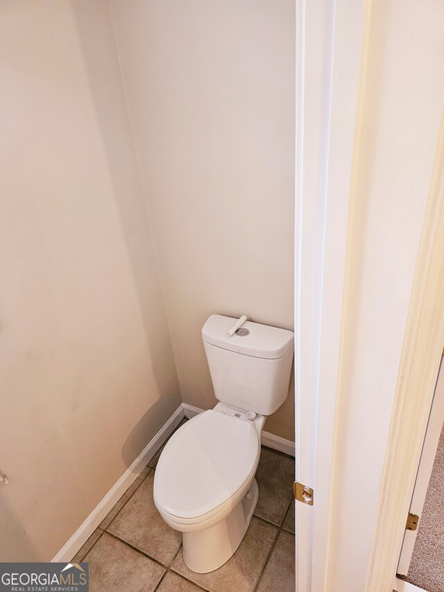 bathroom featuring toilet and tile patterned flooring