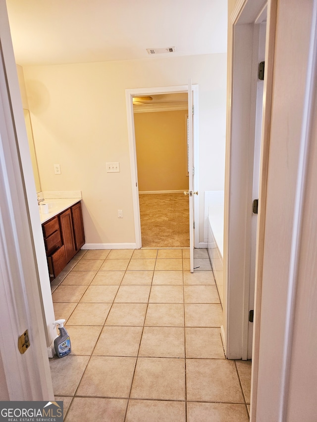 bathroom featuring vanity, a bathing tub, and tile patterned flooring