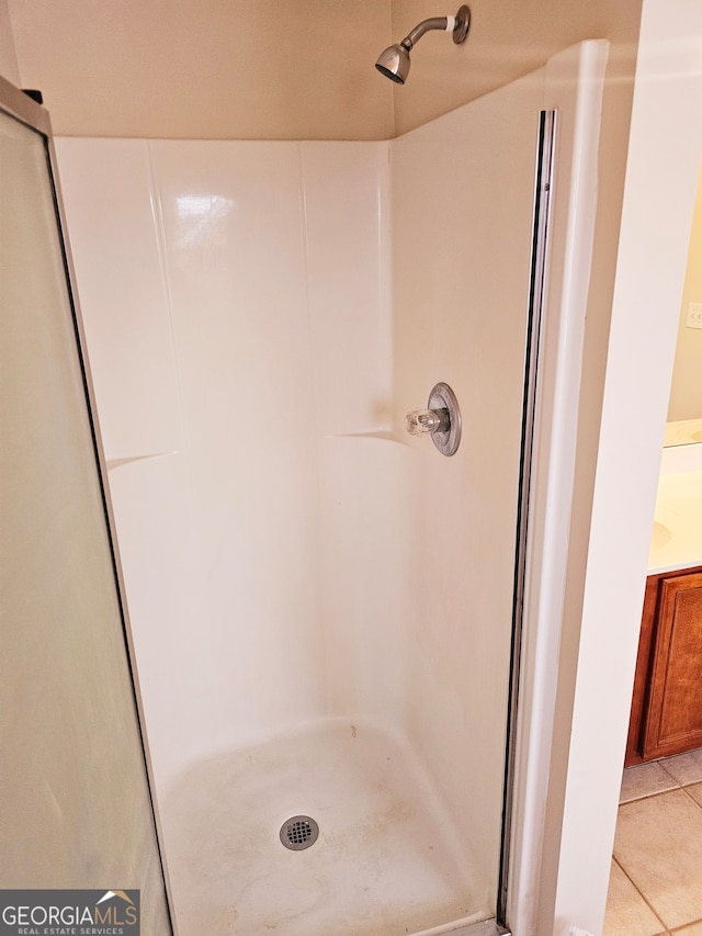 bathroom featuring a shower and tile patterned floors