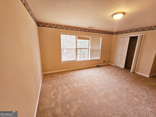 unfurnished bedroom with a closet and carpet flooring