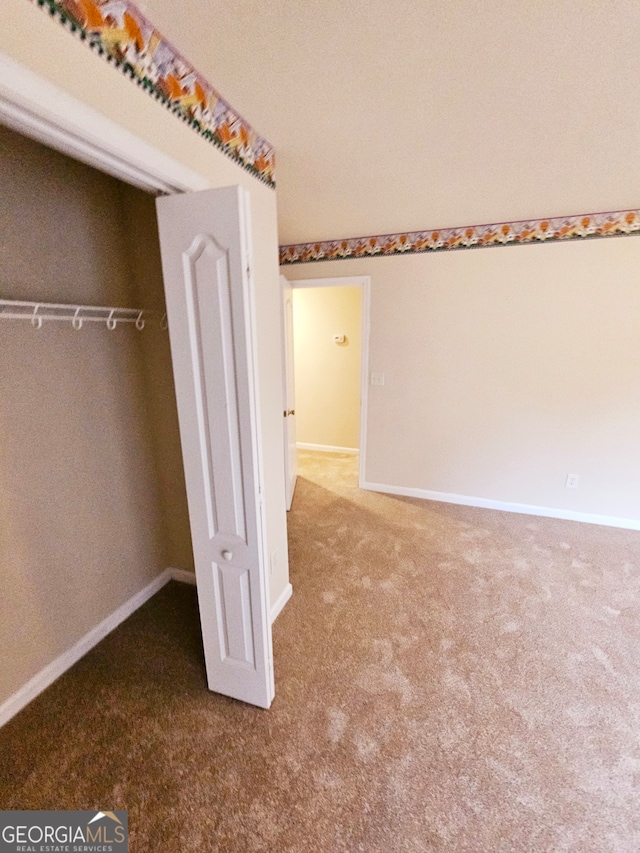 unfurnished bedroom featuring a closet and carpet