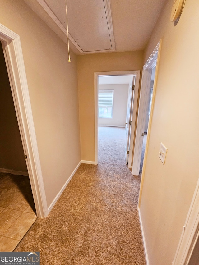 hall with light carpet and a textured ceiling