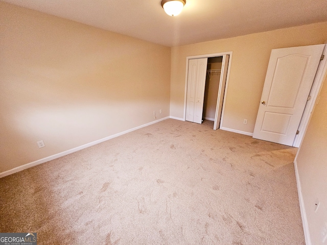 unfurnished bedroom featuring a closet and carpet floors