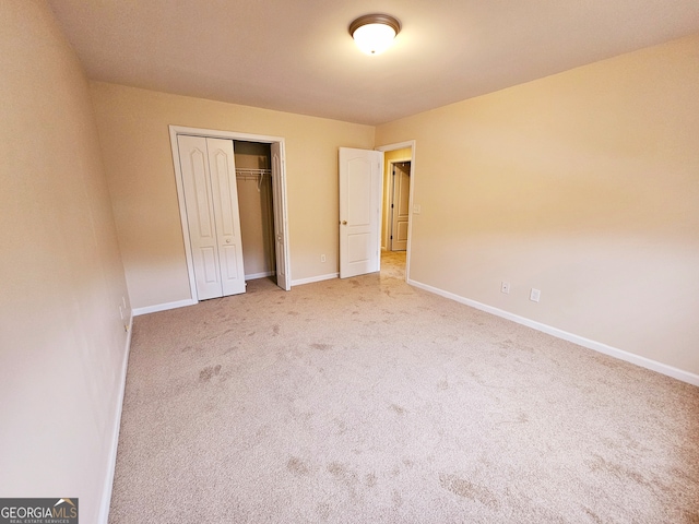 unfurnished bedroom featuring carpet and a closet