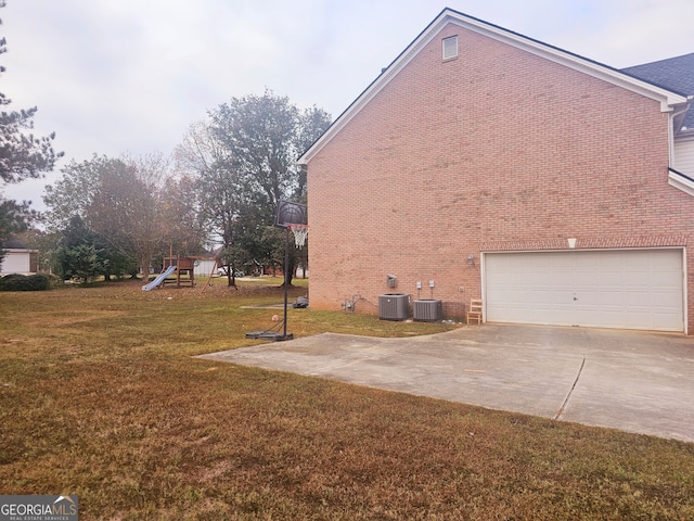 view of property exterior with a playground, central AC unit, a garage, and a lawn